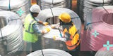 Two technicians handling massive coils of fiber optic cables.